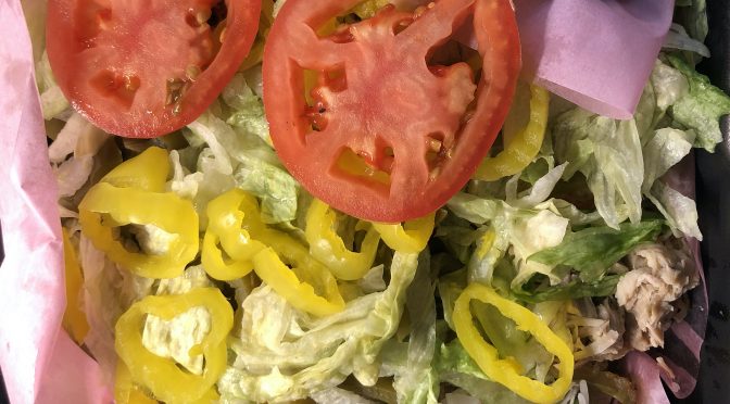 Topped with lettuce, tomatoes, jalapeños and banana peppers, Pollo's chicken stir fry plate has plenty of juicy roast chicken and steaming rice beneath.