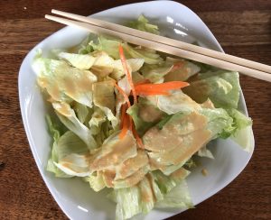 The house salad at ToGo Sushi. It's simple but pleasing, perfectly crisp iceberg lettuce and carrot shreds with plenty of delicious ginger dressing. 