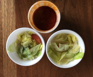 An excellent vinaigrette elevates Queen of Sheba's simple iceberg lettuce salads. We also got a bonus tub of spicy kik wot, red-lentil stew with fiery berbere seasoning.