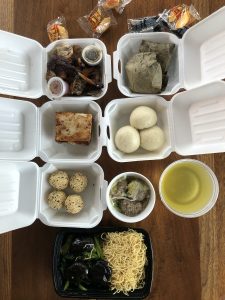 A selection of takeout dim sum from Jade Palace, neatly packed in white plastic foam boxes, fills our dinner table.