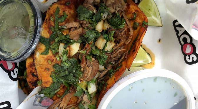 I Love Tacos' birria tacos, a tradition from Guadalajara in Mexico's Jalisco province, feature long-simmered, tender brisket on flour tortillas grilled in a spicy adobo sauce, served in traditional style with cilantro and onion.