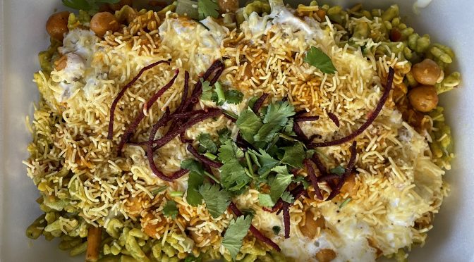 Shreeji's Delhi chaat, an iconic Indian street-food dish, piles sweet, savory, tangy and crunchy toppings over a base of flat wheat crackers.