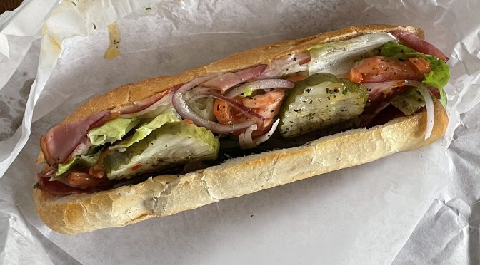 Legacy Pizza's Italian sub offers a meat-lover's selection of ham, capicola, and salami plus provolone, lettuce, tomatoes, pickles and more.