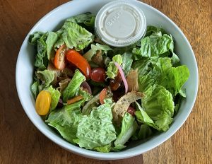 The chef salad at V-Grits includes vegan ham and turkey and coconut bacon along with tomatoes of many colors, fresh crisp lettuce, and more.