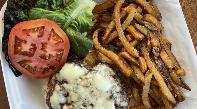 The venison burger at Game is topped with blue cheese. It's normally served on a pretzel bun, but an everything bun filled in nicely when the standard was out of stock.