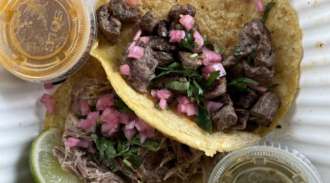 Two of a set of three street tacos on maiz (corn) tortillas at Con Huevos: Slow-roasted pork carnitas (top) and sirloin steak carne asada.