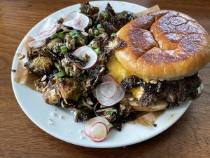 Hog Father's thin, crisp-cooked smash burger is built with tasty toppings on a potato bun.