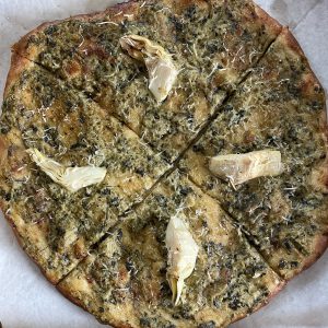 A 10-inch spinach-artichoke pizza is built on a wheat crust, with fresh artichokes and persuasively cheesy vegan cheeses.