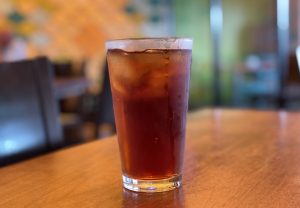 Iced tea was fresh, cold and strong, served in a tall glass. 