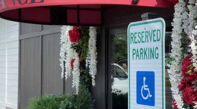 Steak & Bourbon in Westport Village demonstrates easy access, with reserved parking spaces for disabled drivers located adjacent to the accessible main entrance.