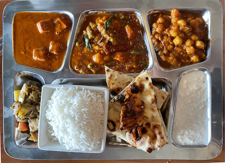 Bombay Grill's thrifty veg platter lunch special offers three curries, app, rice, naan, soup, and more.