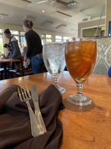Cold, fresh iced tea and a peek at the diner-like row of windows that line the dining room.
