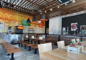Currito's spacious, high-ceilinged room is bright in abstract orange, yellow, red and white, with spare, shiny wood seats and tables, and sports on flat screens around the room.