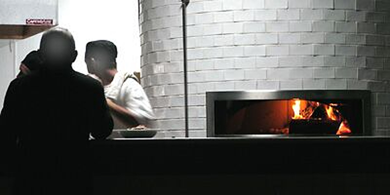 Primo's wood-burning tile pizza oven was a highlight of its stylish dining room.