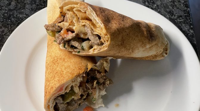 Shawarma loads thin-sliced flank steak, pickles, and veggies into a paper-thin markouk flatbread roll.