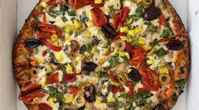 One of the pizzas listed as Bennie's Original Specialties, the veggie pizza piles tangy tomato sauce, melty mozzarella, and crisp, fresh veggies atop a sturdy, bready base.