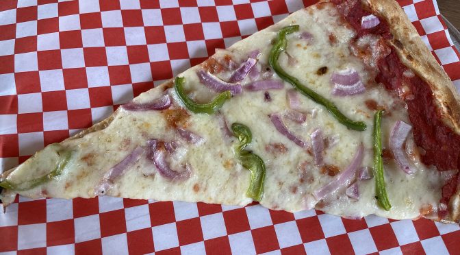 In proper New York City street corner pizzeria style, Goodfellas' slices are long and flexible, allowing the bearer to fold a slice lengthwise and eat it while walking along.