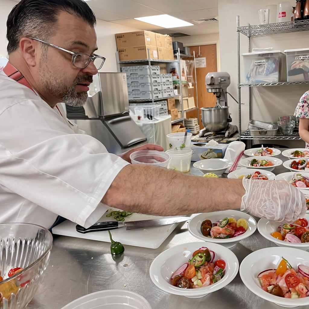 Chef Lamas plates a dozen bowls of shrimp seviche, his Highlands restaurant's namesake dish.