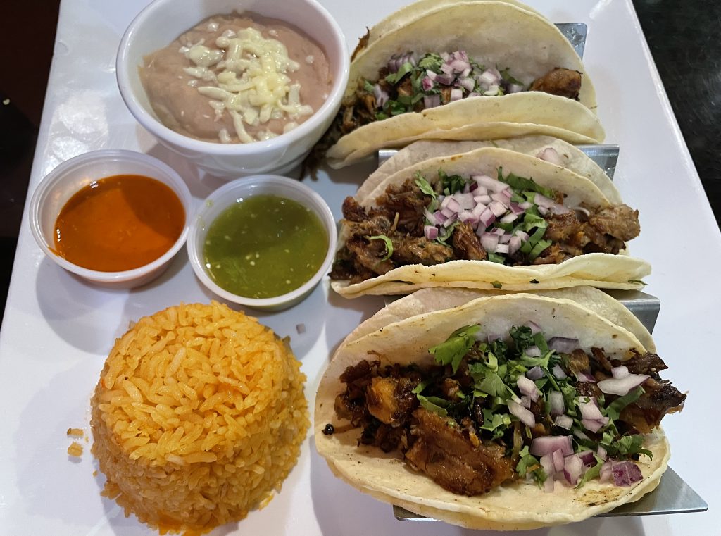 Generously proportioned carnitas tacos are loaded with twice-cooked, seasoned pork and finished in the traditional style with onions and cilantro.