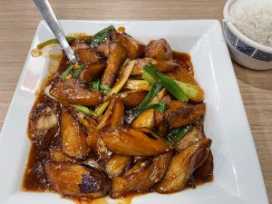 Sichuanese eggplant, marked on the menu with a red chile pepper to signal spice, is piquant but not fiery, full of delicious tender eggplant sauteed with abundant garlic.