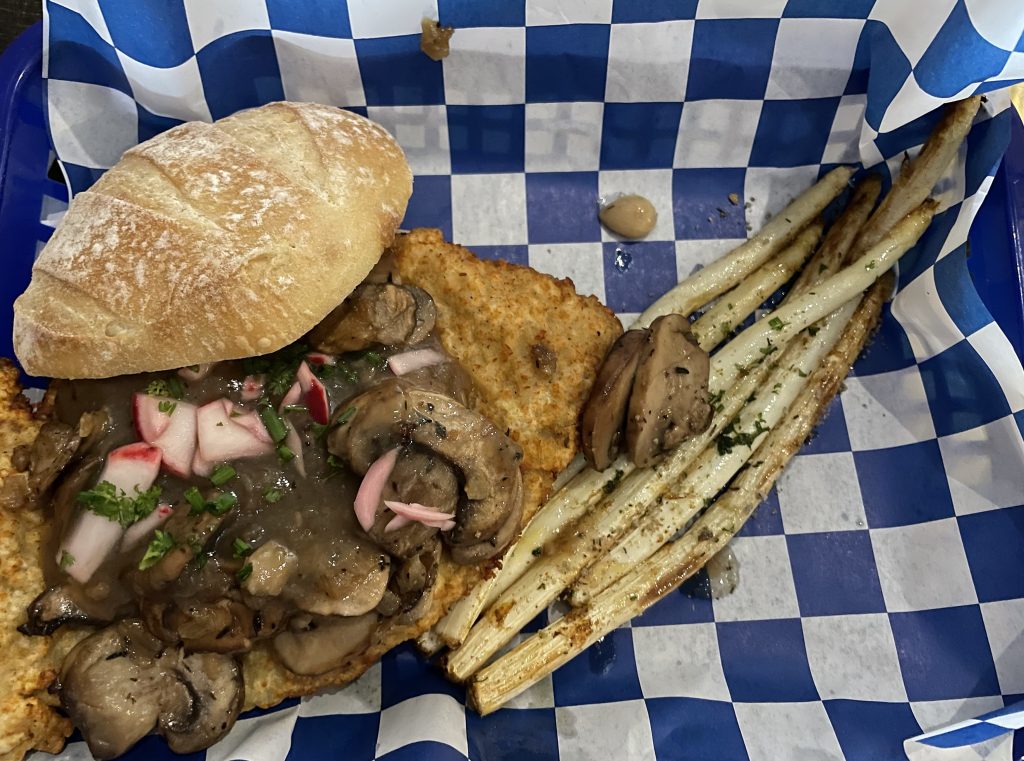 Another 2022 favorite: Pork schnitzel, a classic German dish, comes in a variety of styles at Common Haus. It's available as a full course or, pictured, a Jäger Schnitzel sandwich, with a spring seasonal side of white asparagus.