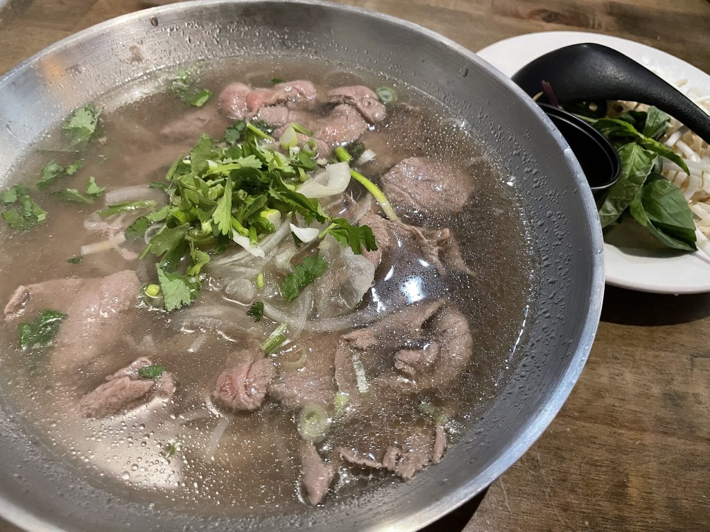 A generous portion of paper-thin beef, noodles, cilantro and onion boosted a rather light broth in a big bowl of beef pho.