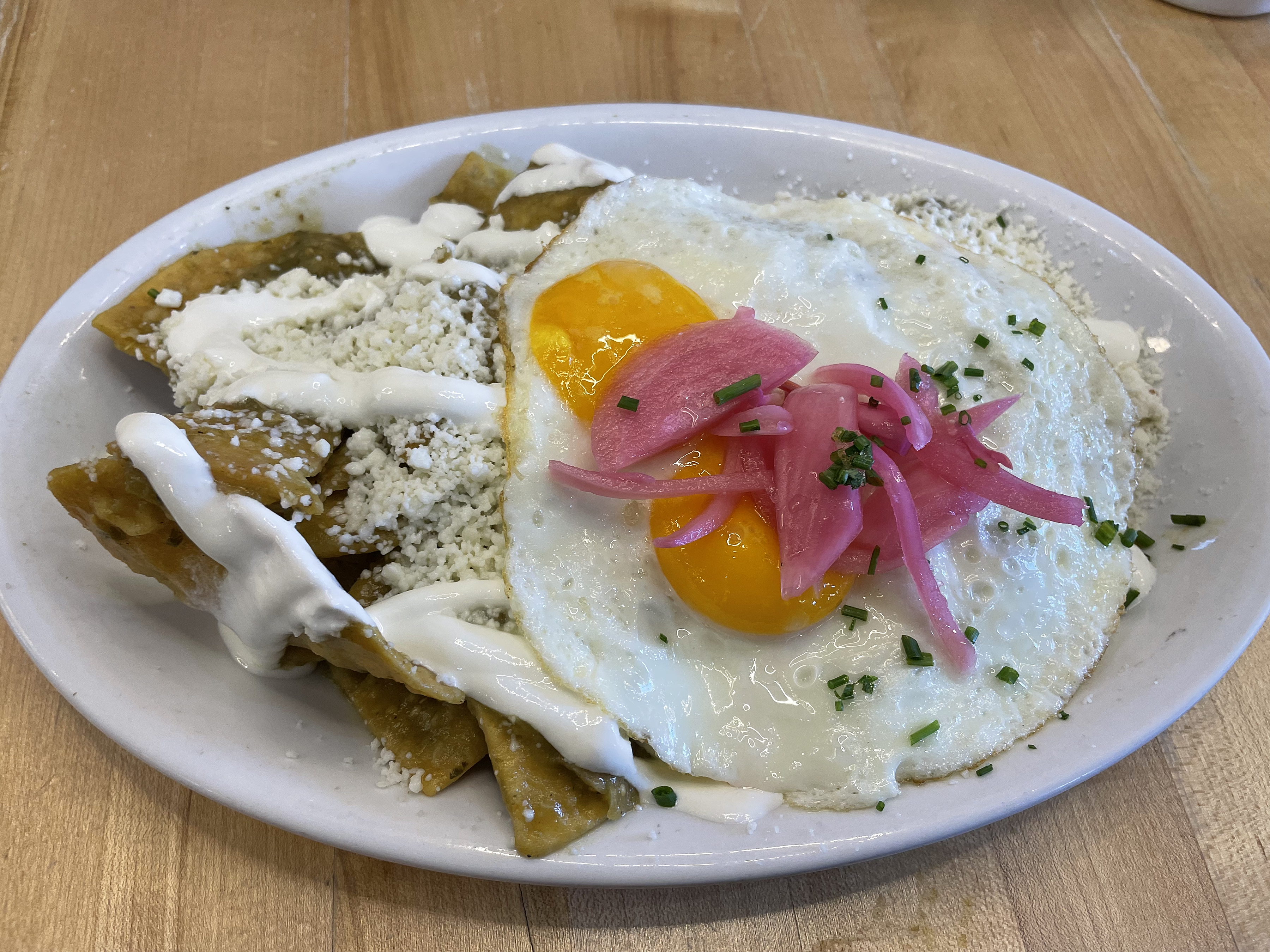 It usually takes me a couple of minutes to figure out how to eat chilaquiles, but I never regret ordering Con Huevos' version of this filling breakfast dish.