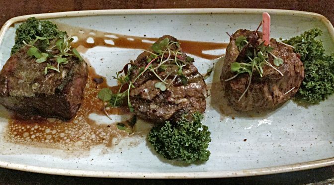 Local steakhouses often qualify as magical eateries. Le Moo’s 18-ounce tenderloin flight – Wagyu, Prime, and Choice – during a 2016 visit.
