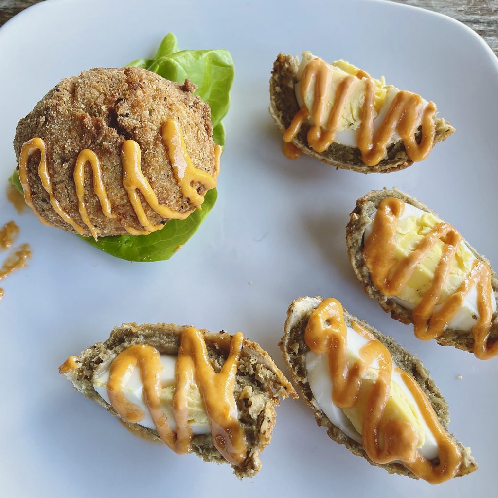 Scotch eggs make a filling starter: Hard-boiled henfruit is cloaked in mild sausage (veggie sausage is also available). then clad in a firm shell of fried panko breading.
