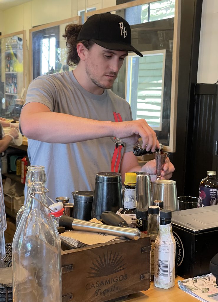 Harrison Wells, bartender at Cultured – Cheese and Charcuterie Bar on East Main Street, fashions a simple but impressive mocktail with Modica mixers.