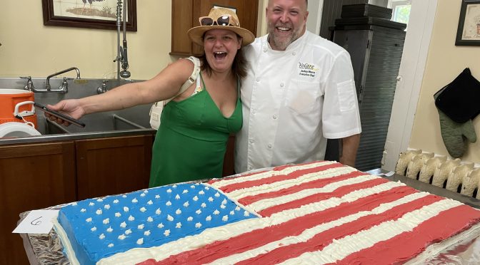 Crescent Hill Old Fashioned Fourth of July Cake Judges Caity DiFabio and Joshua Moore look hungrily at Squish Schmidt's American Flag cake, a giant creation that won the Unicorn award for most patriotic entry.