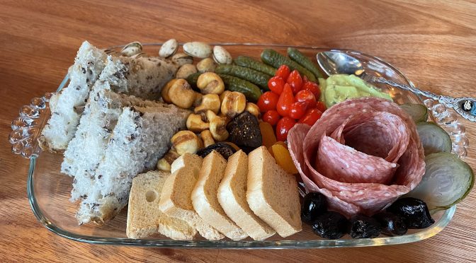 You can choose charcuterie plates with varieties of meat and cheese, but we kept it simple with a rose-like round of thin-sliced fennel-scented finnochiona salami and a happy contingent of accompaniments.