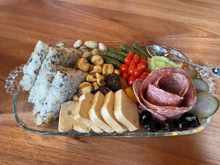 What's a charcuterie plate? This item from Harvey's tells the story: It's an artful display of meat and cheese: a rose-like round of thin-sliced fennel-scented finnochiona salami and a happy contingent of accompaniments.