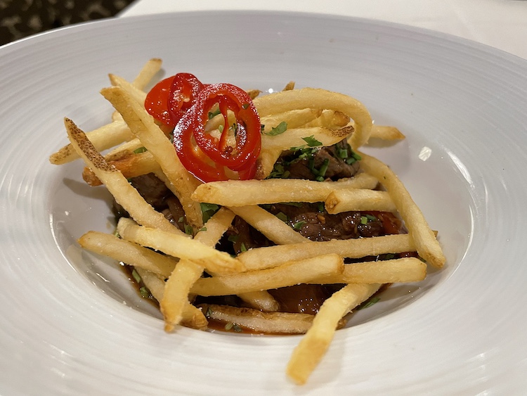 Lomo saltado, a steak with a Peruvian accent, is a beefy appetizer big enough to serve as a main dish at Anoosh Bistro. It's topped with crisp fries and zippy red peppers. You could avoid the fries to save calories, but why?