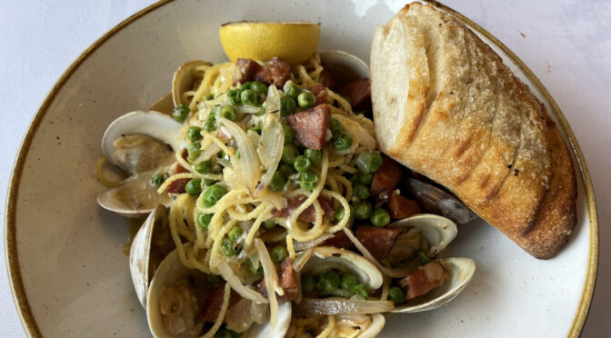 Tiny littleneck clams in the shell and spicy Portuguese linguiça sausage meet and mingle in this hearty spaghetti con vongole.