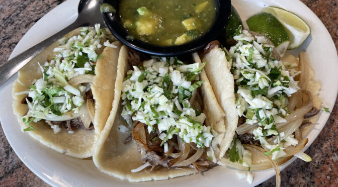 Guatemalan style tacos: Tasty, spicy shredded beef is piled into three soft, freshly made corn tortillas.