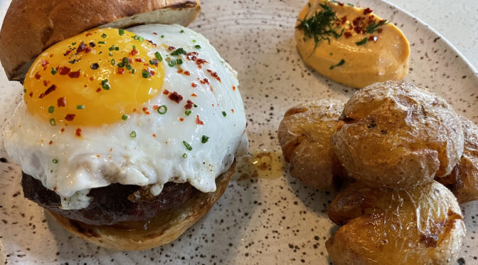 Almost as big around as an oversize meatball, Paseo's lamb burger comes with a fried egg on top and more, much more.