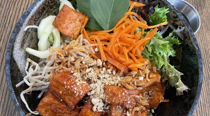 Bun thit nuong, a hearty South Vietnamese rice-noodle dish, is available with tofu (pictured) or, in its traditional form, grilled pork loin, tossed with salad fixings and crushed peanuts.