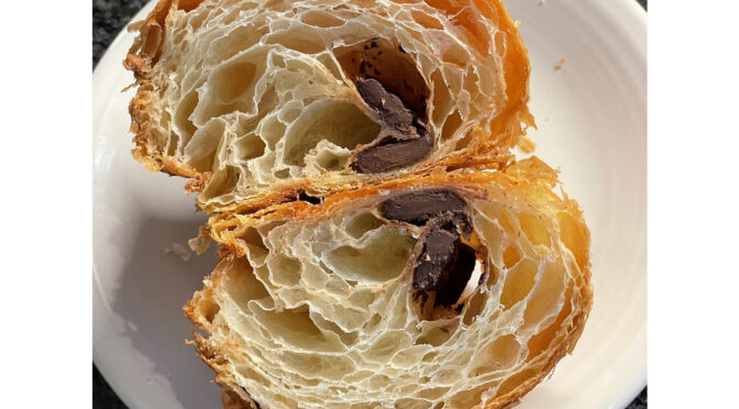 The laminated construction of perfectly fashioned French-style croissants like this chocolate-stuffed model show up as a pretty pattern of air holes filling the sweet, tender pastry.