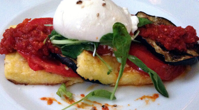 Polenta Pave at Jack Fry's: Thin layers of tomato, roasted eggplant and sun-dried tomato jam stacked on slabs of smooth yellow-corn polenta and topped with an oval of creamy, rich burrata cheese. Photo from a 2014 review.