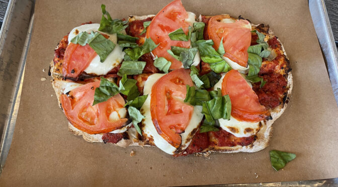 Banditz Pizza's margherita pie is built on an oval base of fresh, crisp flatbread and topped with the traditional tomatoes, mozzarella, and basil.